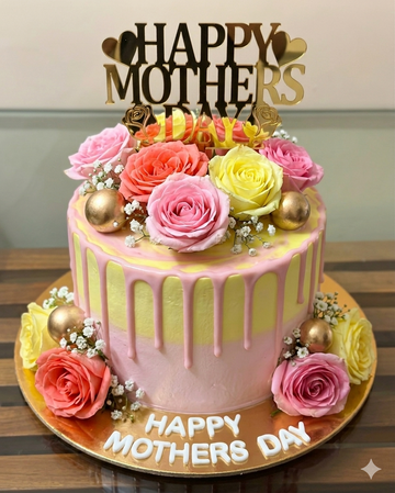 : A tall pink and yellow drip cake topped with fresh roses and a gold "Happy Mother's Day" topper.