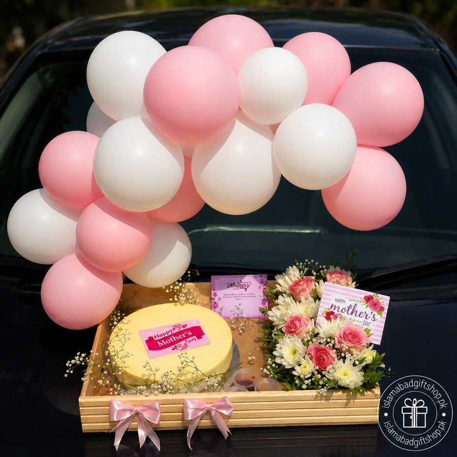 Luxury Mother’s Day gift tray with pink and white balloon arch, yellow cake, pink rose flower arrangement, greeting cards, ribbon bows
