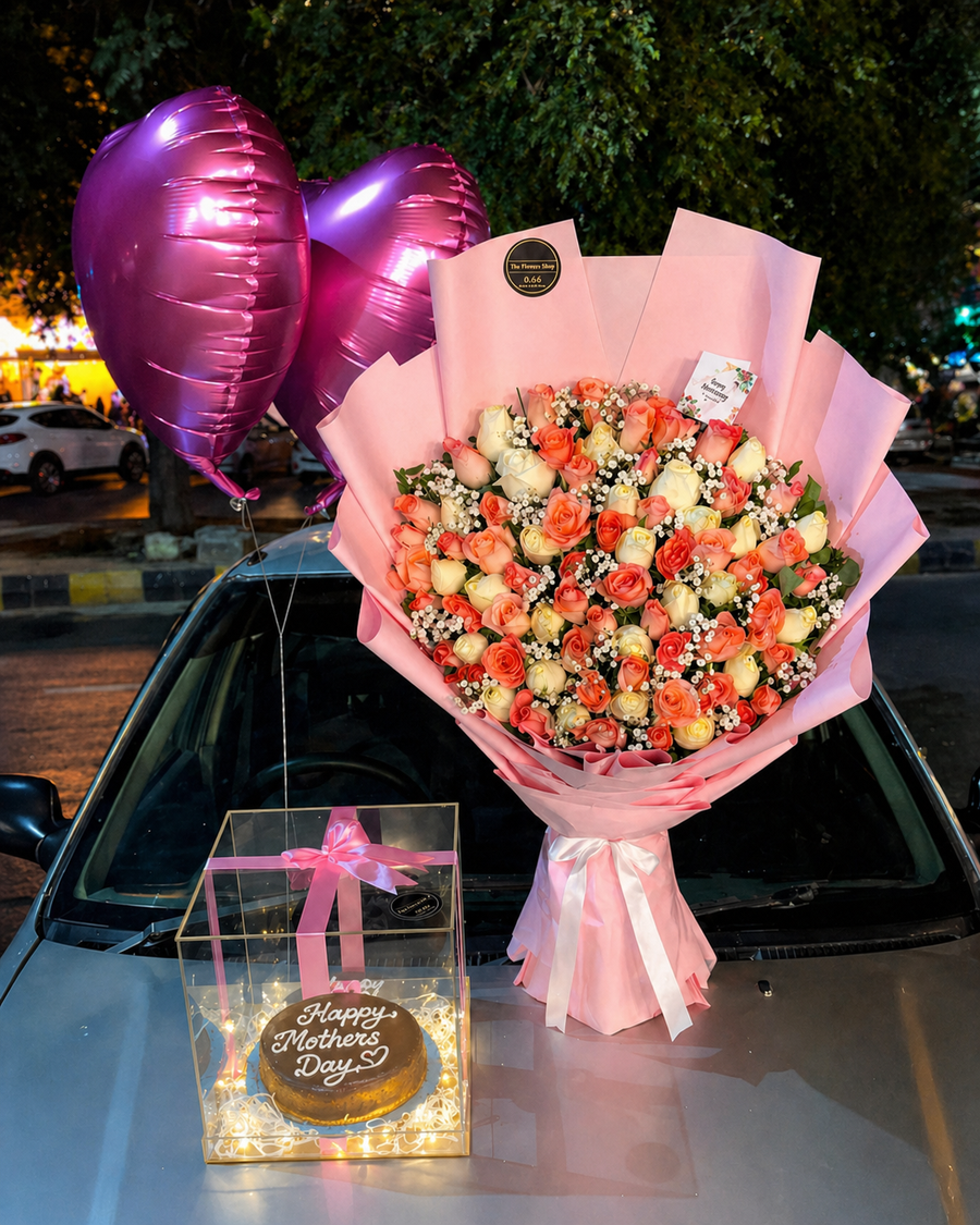 Luxury Mother’s Day gift set with pink rose bouquet, metallic heart balloons, and LED-lit cake box displayed on a car hood at night.