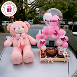 Pink teddy bear birthday gift set with Happy Birthday Gorgeous balloons, chocolate cake, flowers, candies